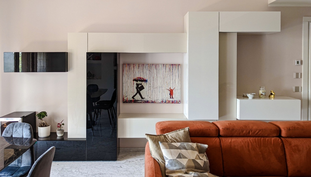 Scaffalatura a parete in un salotto moderno con divano arancione